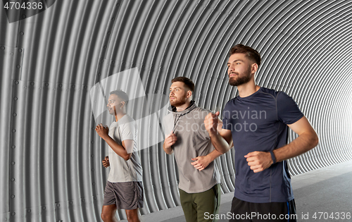 Image of young men or male friends running outdoors