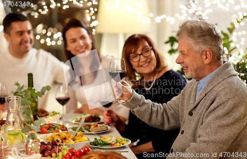 Image of happy family having dinner party at home