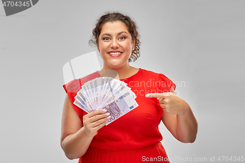 Image of happy woman showing euro money banknotes