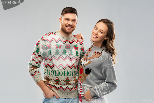 Image of happy couple at christmas ugly sweater party