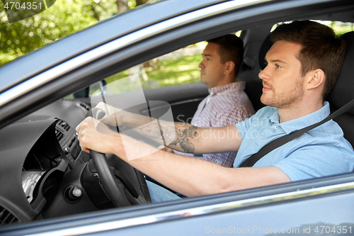 Image of car driving school instructor and male driver