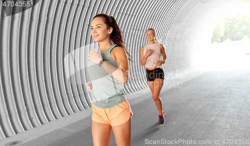 Image of young women or female friends running outdoors