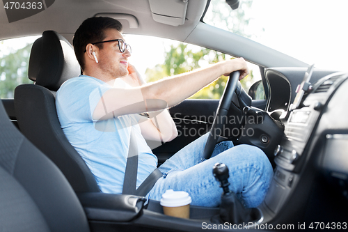 Image of man or driver with wireless earphone driving car