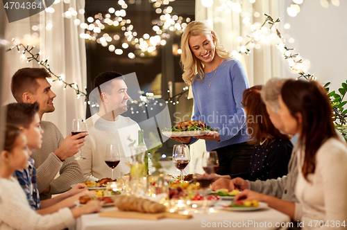 Image of happy family having dinner party at home