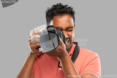 Image of indian man or photographer with digital camera