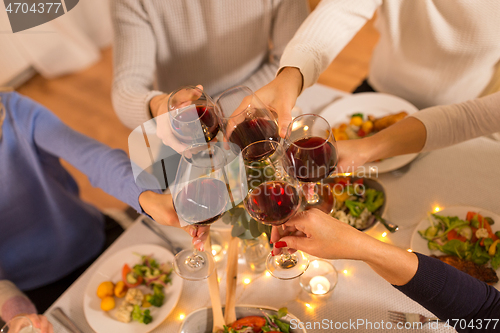 Image of happy family having dinner party at home