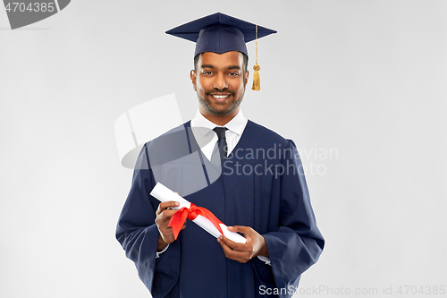 Image of male graduate student in mortar board with diploma