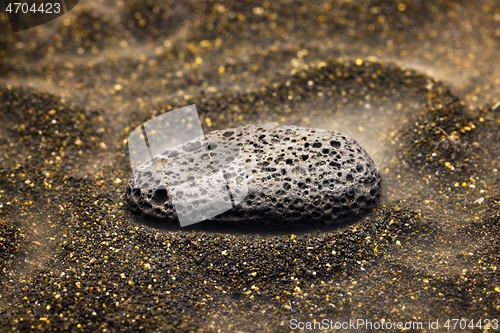 Image of Smoke whirling around small meteorite stone