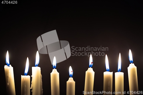 Image of Candles glowing against dark background