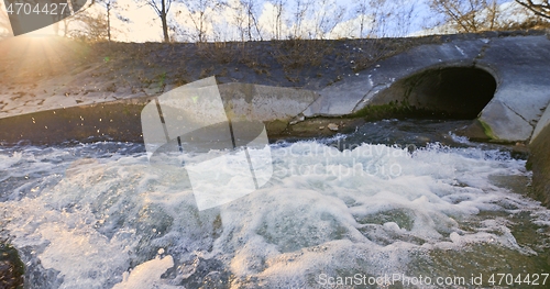 Image of Large sewage tunnel with filth flowing out