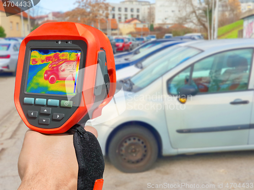 Image of Recording with thermal camera showing parked cars at town parkin