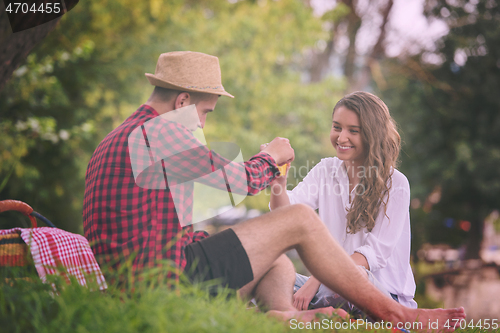 Image of Couple in love enjoying picnic time