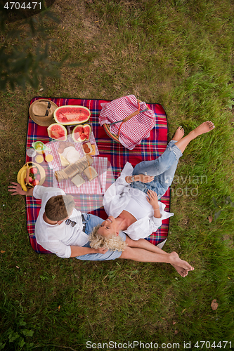 Image of top view of couple enjoying picnic time