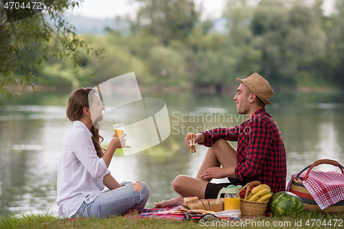 Image of Couple in love enjoying picnic time