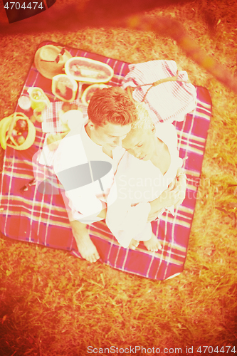 Image of top view of couple enjoying picnic time