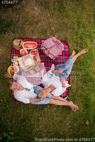 Image of top view of couple enjoying picnic time