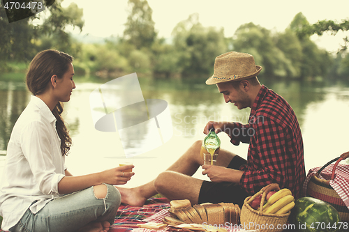 Image of Couple in love enjoying picnic time