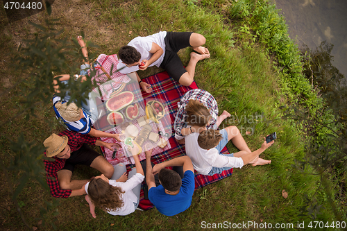 Image of top view of group friends enjoying picnic time