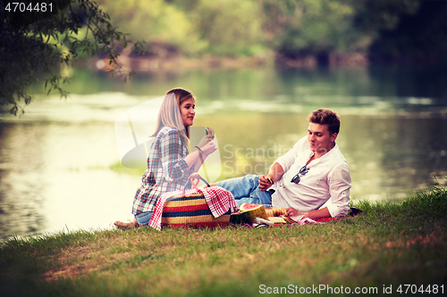 Image of Couple in love enjoying picnic time