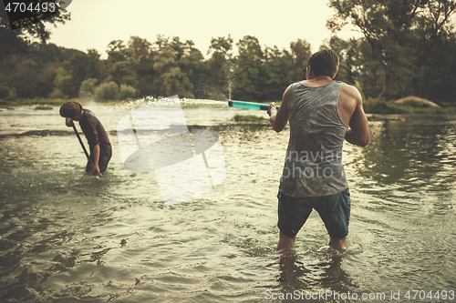 Image of young men having fun with water guns