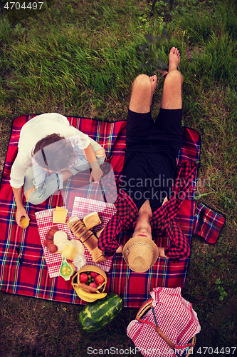 Image of top view of couple enjoying picnic time