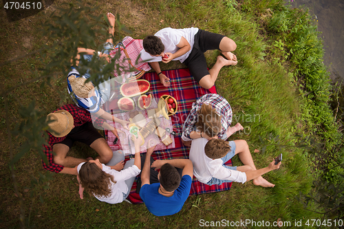 Image of top view of group friends enjoying picnic time