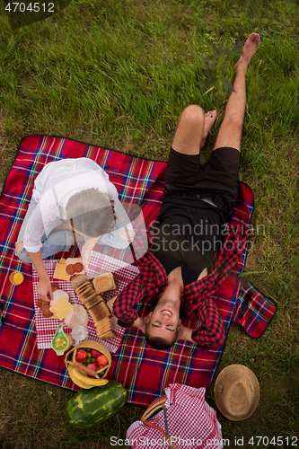 Image of top view of couple enjoying picnic time