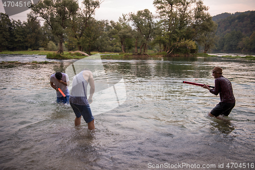 Image of young men having fun with water guns