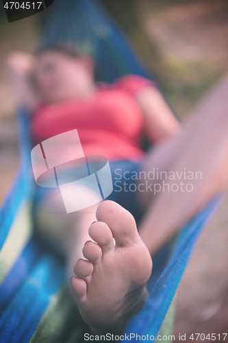 Image of woman resting on hammock