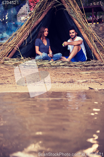 Image of couple spending time together in straw tent