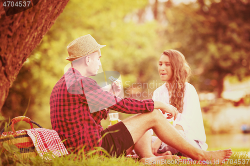 Image of Couple in love enjoying picnic time