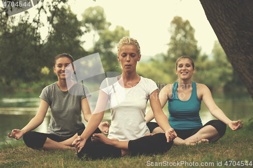 Image of women meditating and doing yoga exercise