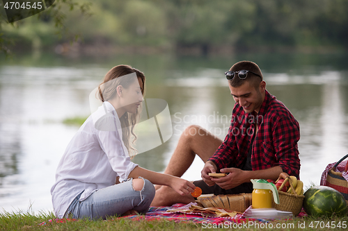 Image of Couple in love enjoying picnic time