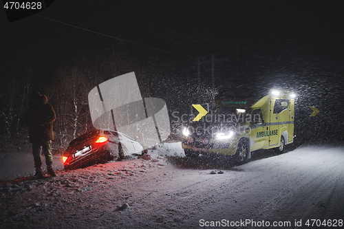 Image of car accident on slippery winter road at night