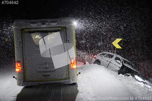 Image of car accident on slippery winter road at night