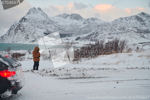 Image of Muslim traveler praying in cold snowy winter day