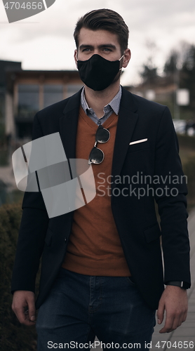 Image of business man wearing protective face mask at luxury office