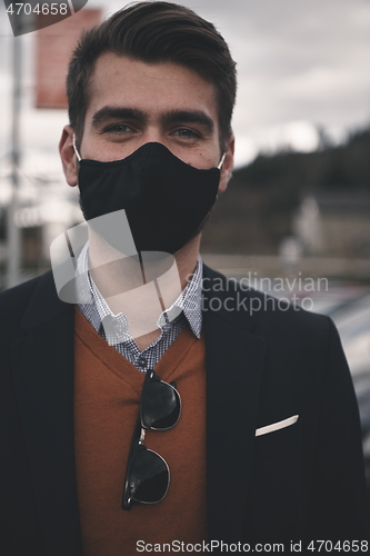 Image of business man wearing protective face mask at luxury office