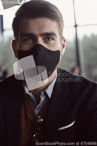 Image of business man wearing protective face mask at luxury office