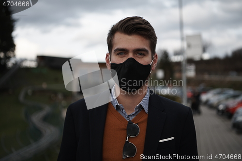 Image of business man wearing protective face mask at luxury office