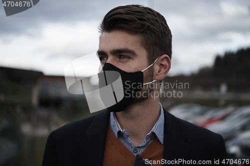 Image of business man wearing protective face mask at luxury office