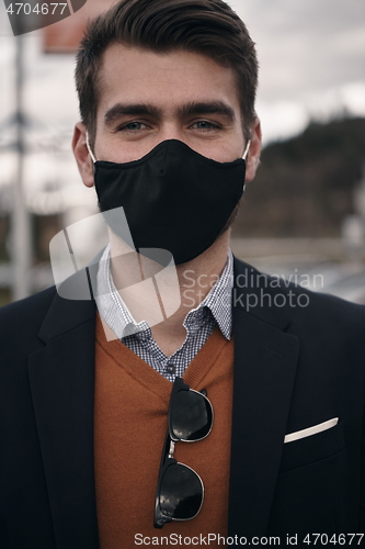 Image of business man wearing protective face mask at luxury office