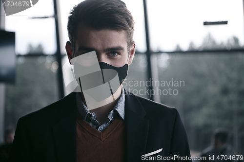 Image of business man wearing protective face mask at luxury office