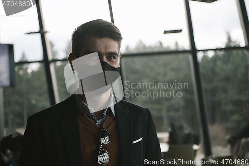 Image of business man wearing protective face mask at luxury office