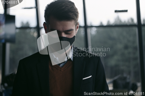 Image of business man wearing protective face mask at luxury office