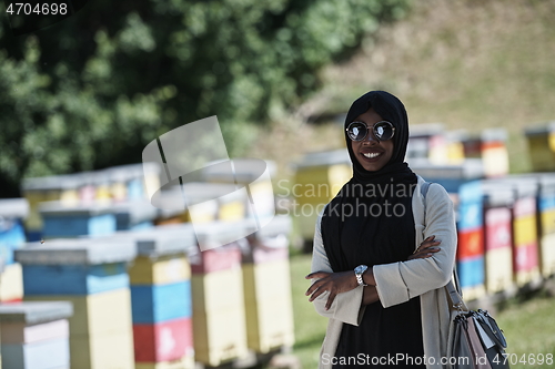 Image of african muslim businesswoman portrait on small local honey production farm