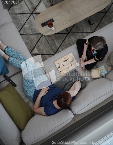 Image of mother and daughter at home playing memory game