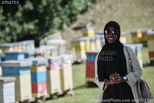 Image of african muslim businesswoman portrait on small local honey production farm