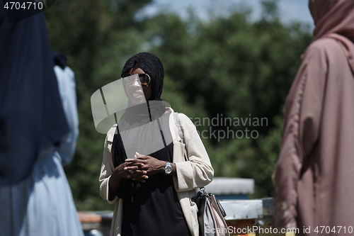 Image of woman giving presentation to group of business investors on local honey production farm