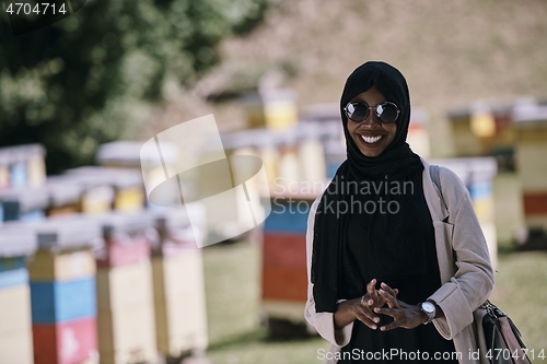 Image of african muslim businesswoman portrait on small local honey production farm